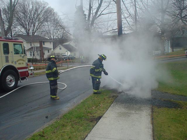 IFCO members douse melting sidewalk after wires down. Grove St. 3/22/10
