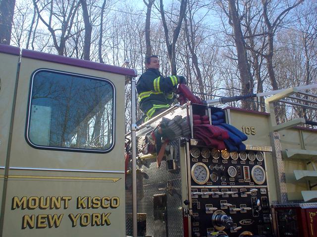 Engineer Jon Pucila, operates E-105's deck gun at drafting drill. (3/21/09)