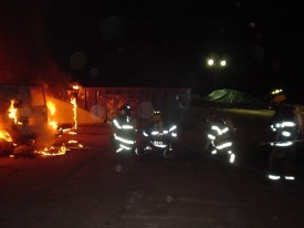 Members move in to extinguish a working van fire