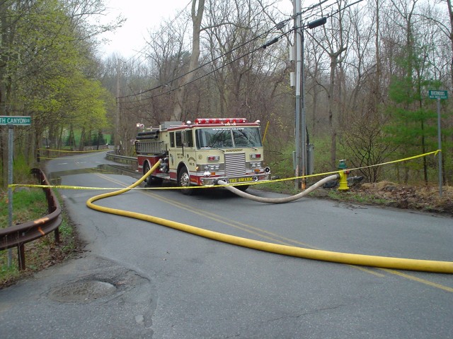 E-106 (retired) pumps from a hydrant on Pines Bridge Road. A pumper relay was established to provide water to a working fire at Yeshiva Farms. 
